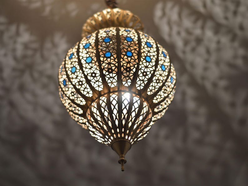 Handmade Moroccan Brass Lantern Pendant Light – Ornate Pierced Globe Hanging Lamp with Blue Glass Accents and Dramatic Moorish Shadow Patterns for Entryway, Bedroom & Living Room