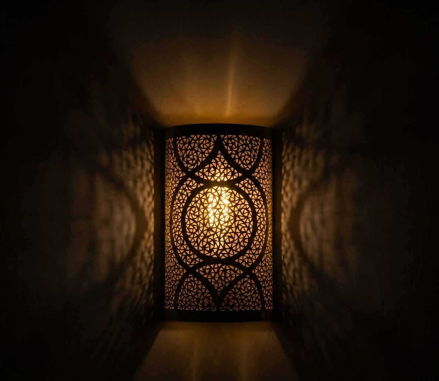 Handmade Moroccan Brass Cylinder Wall Sconce – Pierced Geometric Wall Light with Circular Arabesque Pattern, Warm Golden Glow and Dramatic Shadow Projection