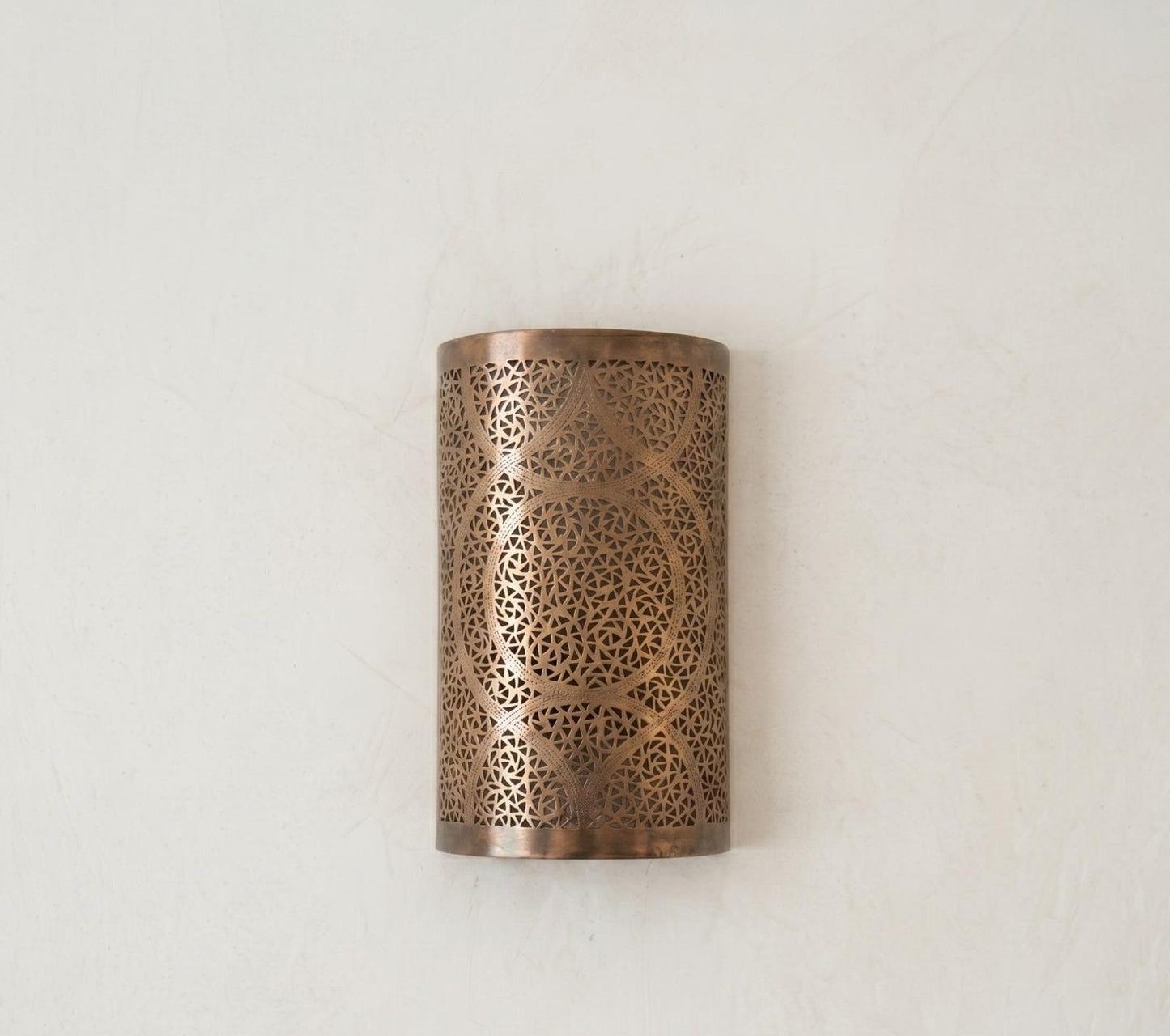 Handmade Moroccan Brass Cylinder Wall Sconce – Pierced Geometric Wall Light with Circular Arabesque Pattern, Warm Golden Glow and Dramatic Shadow Projection
