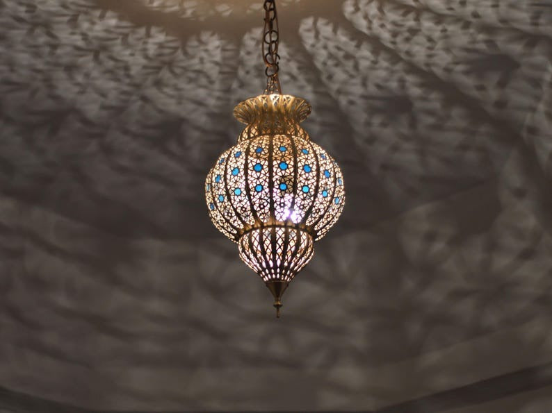 Handmade Moroccan Brass Lantern Pendant Light – Ornate Pierced Globe Hanging Lamp with Blue Glass Accents and Dramatic Moorish Shadow Patterns for Entryway, Bedroom & Living Room