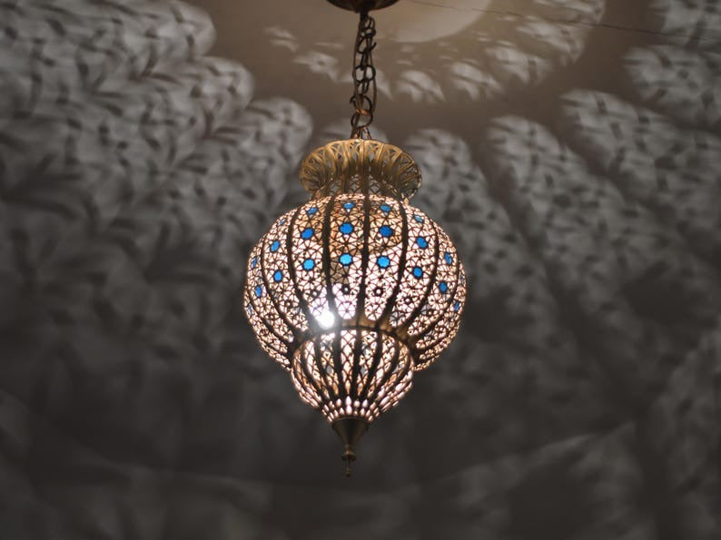 Handmade Moroccan Brass Lantern Pendant Light – Ornate Pierced Globe Hanging Lamp with Blue Glass Accents and Dramatic Moorish Shadow Patterns for Entryway, Bedroom & Living Room