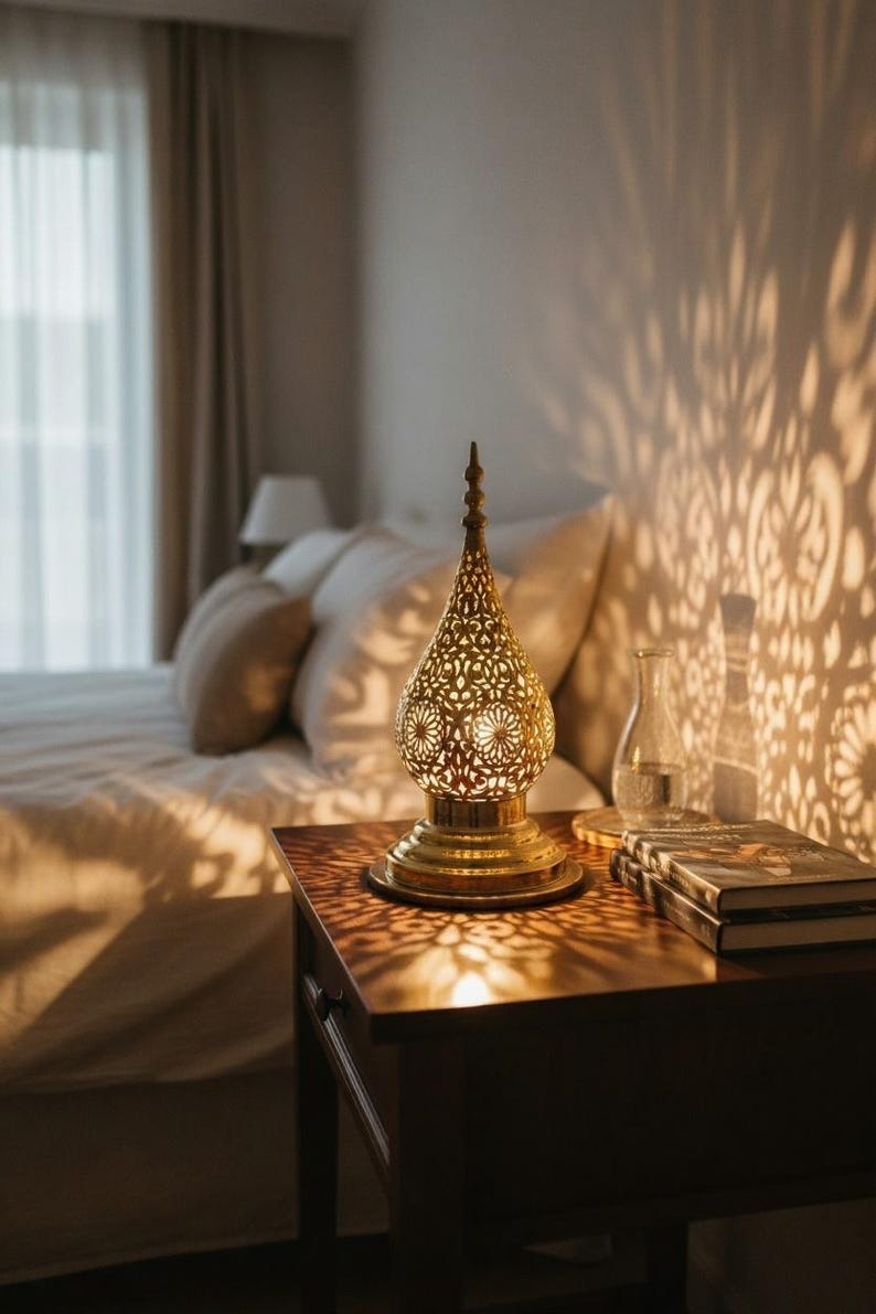 Handmade Moroccan Brass Teardrop Table Lamp – Ornate Pierced Brass Lantern with Floral Arabesque Cutouts, Warm Gold Glow and Dramatic Shadow Patterns