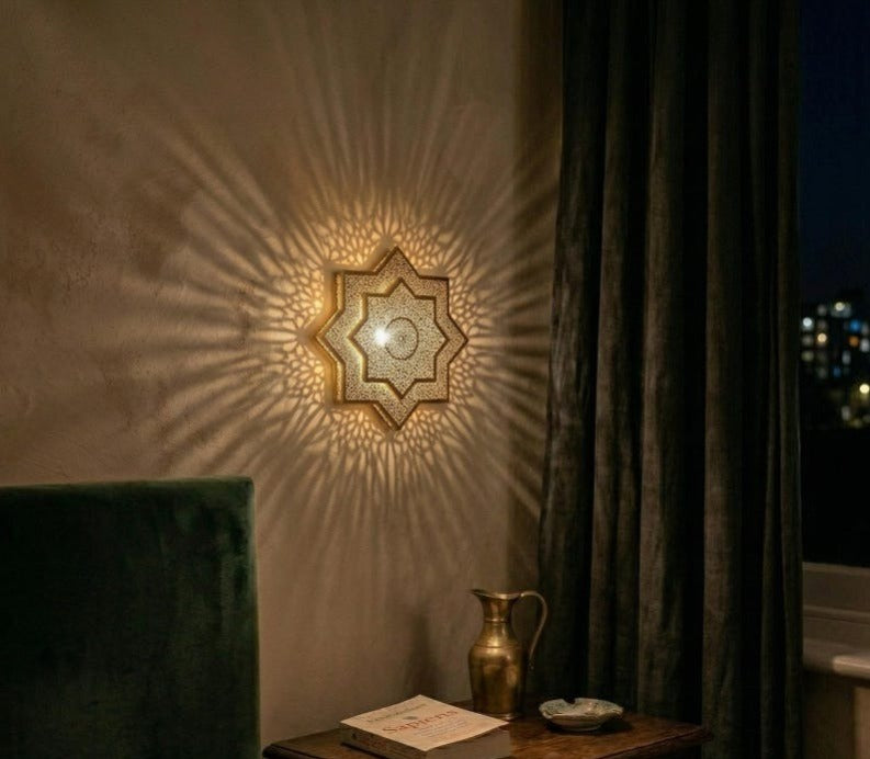 Handmade Moroccan Brass Star Wall Sconce – Pierced Eight-Point Geometric Wall Light with Warm Golden Glow and Dramatic Sunburst Shadow Patterns
