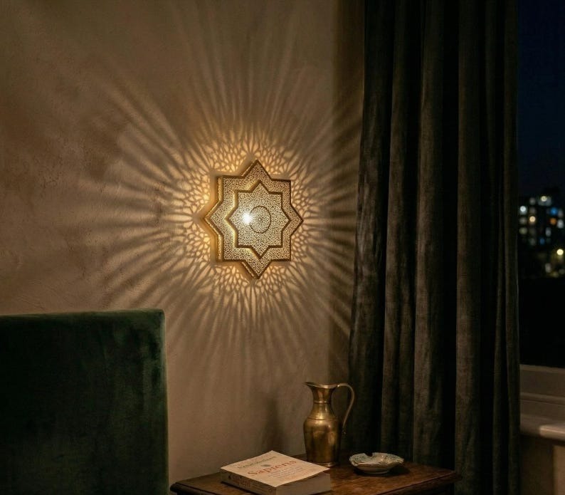 Handmade Moroccan Brass Star Wall Sconce – Pierced Eight-Point Geometric Wall Light with Warm Golden Glow and Dramatic Sunburst Shadow Patterns