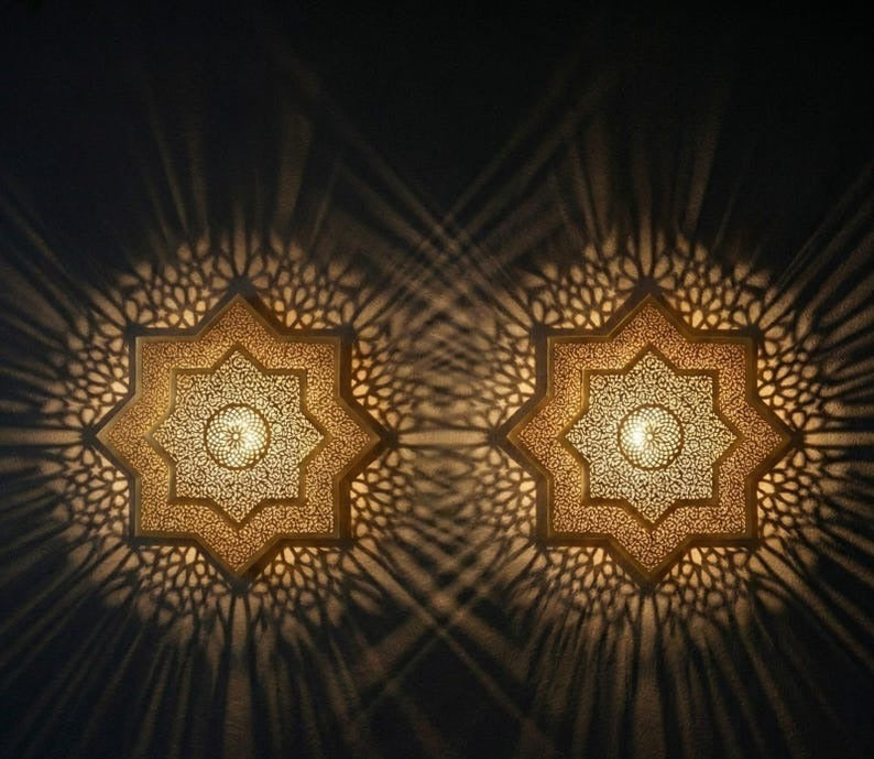 Handmade Moroccan Brass Star Wall Sconce – Pierced Eight-Point Geometric Wall Light with Warm Golden Glow and Dramatic Sunburst Shadow Patterns