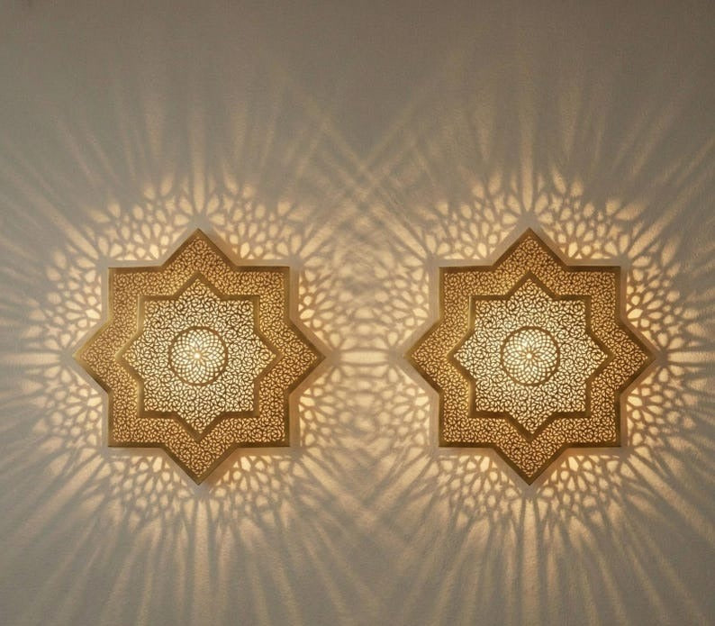 Handmade Moroccan Brass Star Wall Sconce – Pierced Eight-Point Geometric Wall Light with Warm Golden Glow and Dramatic Sunburst Shadow Patterns