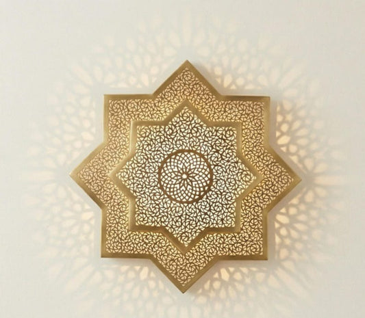 Handmade Moroccan Brass Star Wall Sconce – Pierced Eight-Point Geometric Wall Light with Warm Golden Glow and Dramatic Sunburst Shadow Patterns